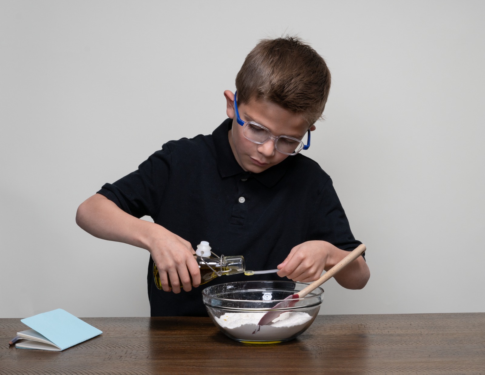Boy mixing ingredients in a bowl during a Keko activity