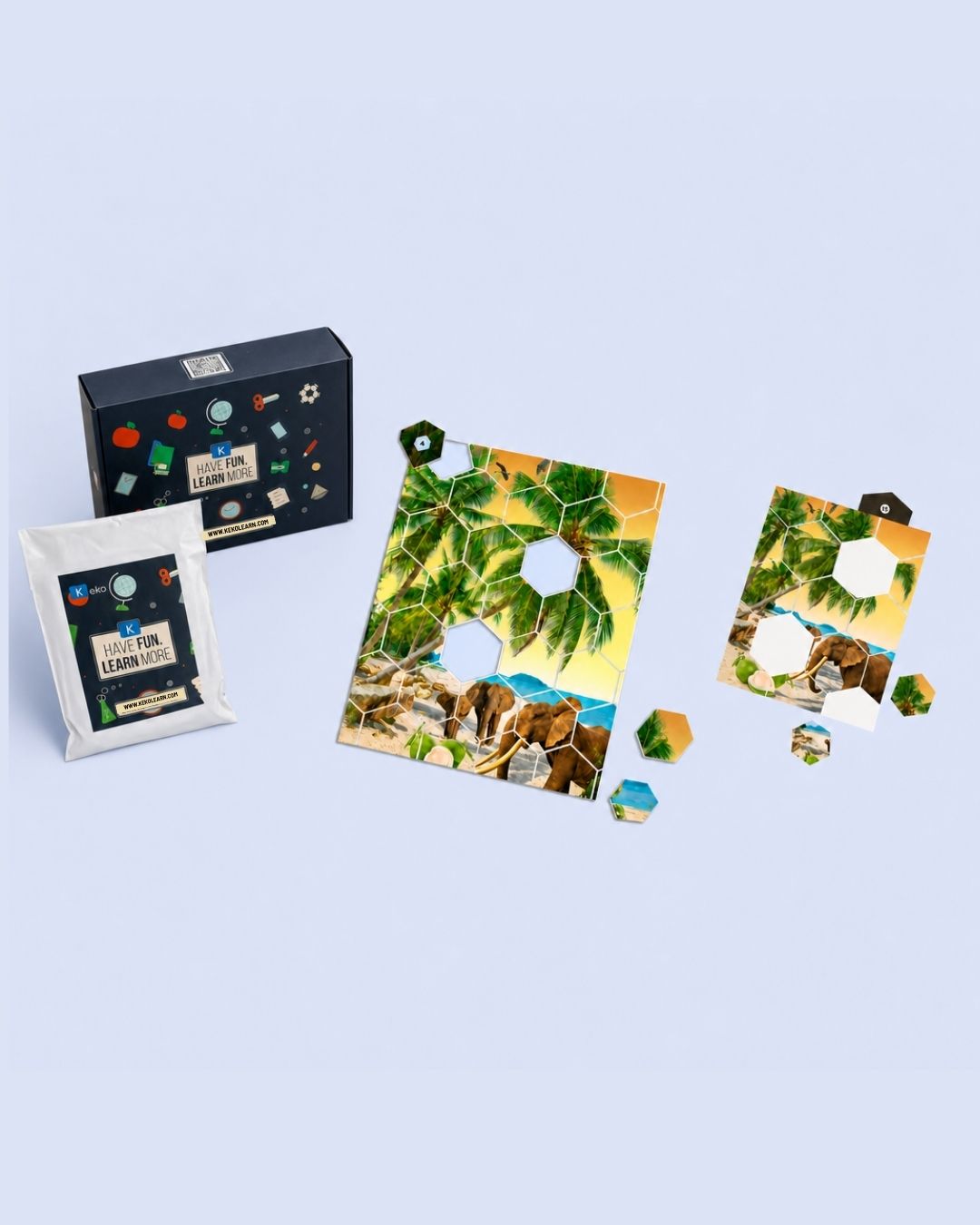 Keko math puzzle box contents — large puzzle, small puzzle, puzzle pieces, answer key tile, prompt booklet, notebook and pencil, and drawstring pouch