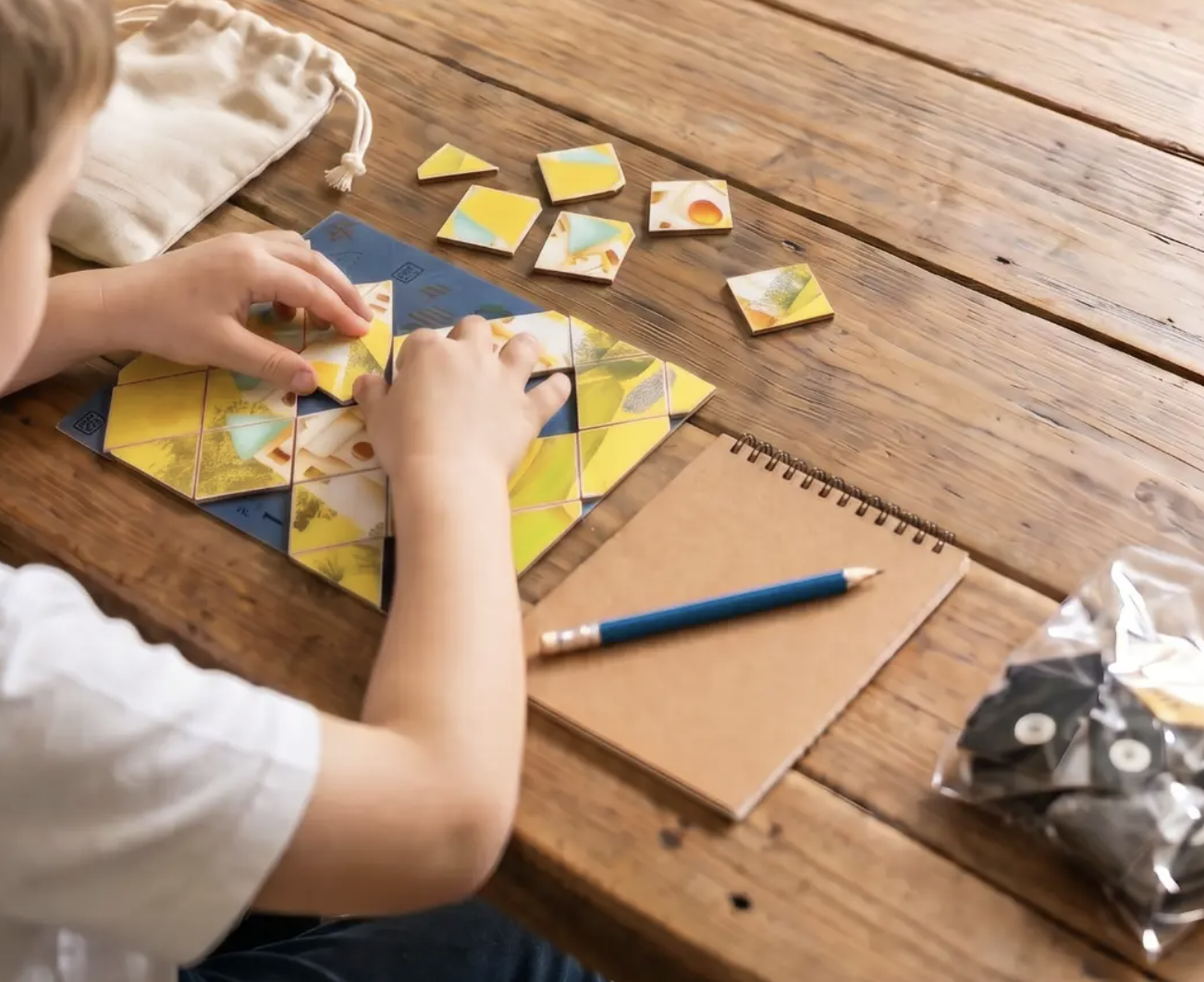 Child's hands assembling a hexagonal Keko math puzzle