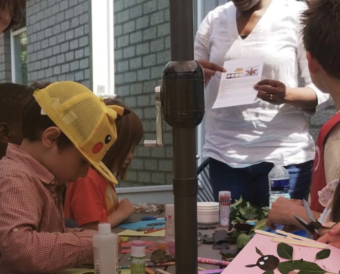 Children crafting with leaves and natural materials at a Keko workshop table